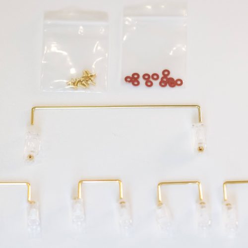 Clear Durock V2 stabilizers with gold wires, gold screws, and red screw dampener pads for DIY mechanical keyboards..