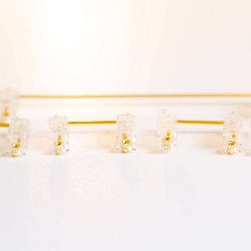 Clear Durock V2 stabilizers with gold wires for custom mechanical keyboards.